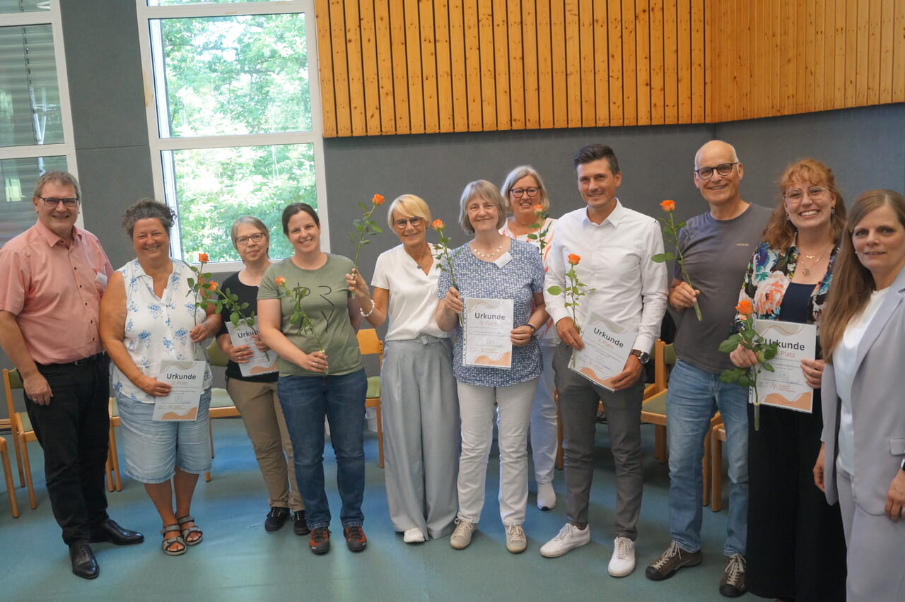 Superintendentin Kerstin Grünert (r.) und Pfarrer Jochen Wahl (l.) vom Innovationsfonds „Aufbruch 57“ gratulierten den Gewinnerinnen und Gewinner des Wettbewerbs „Schatz im Acker“.